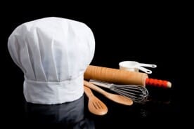 chef's toque blanche and cooking utensils