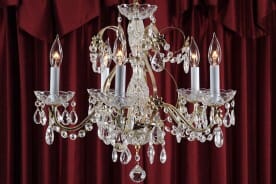 beautiful chandelier with dark red curtains in the background