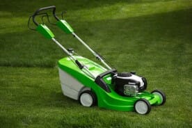 Lawn Mower on a Green Lawn