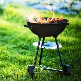 a barbecue grill with orange flames